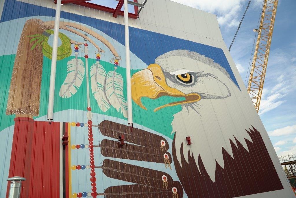 A large mural on steel panels of an eagle and Eagle Staff.